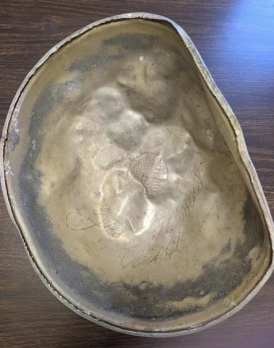 The top of the dome was pretty battered by the time they got it off. Commander Greg Smith isn’t even sure what prompted them to take it off, but the treasure waiting inside was worth the effort. Written inside is “Joe Sejvar Plumbing.”
