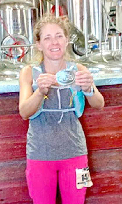 Melissa Schenefeld shows the buckle she earned for completing the Cowboy 100. (Running from Atkinson to Valentine, NE) (Submitted photo)