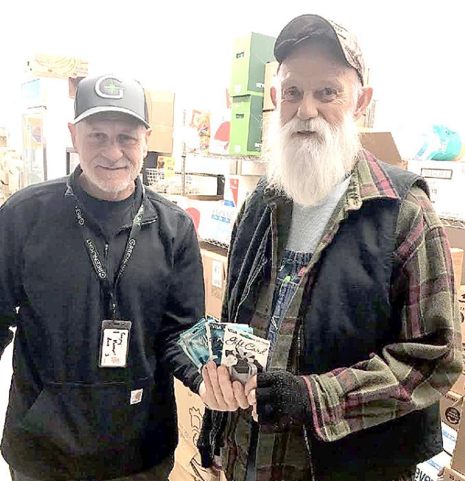 Rod Dobesh of Greenlight Dispensary donated five $100 gift cards to local residents in need recently. Ed Nebola of Wear N Wares helped identify the recipients.