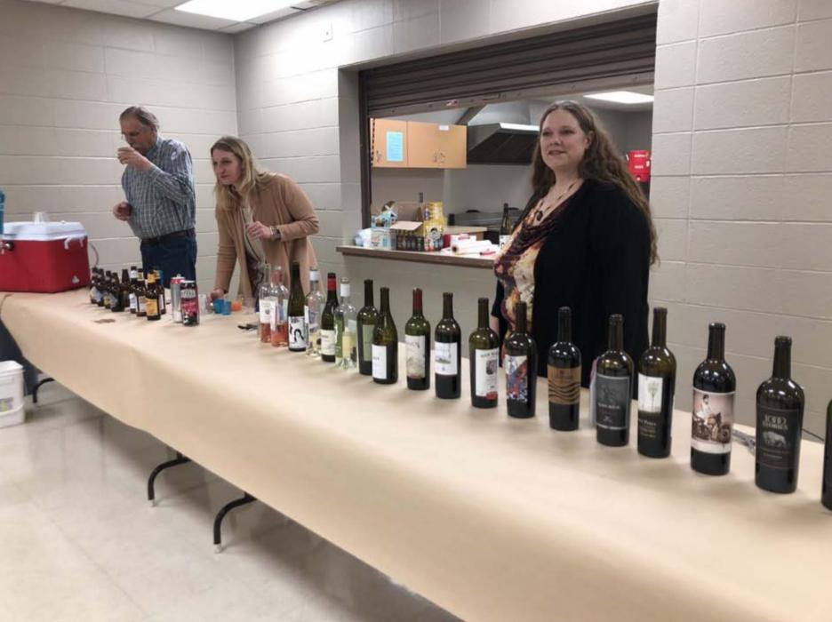 Dr. John Malm, Claudia Shaffer, and Tara Engel staffed the bar, and occasionally sampled the wide variety of offerings, at last year’s Kegs &amp; Corks.