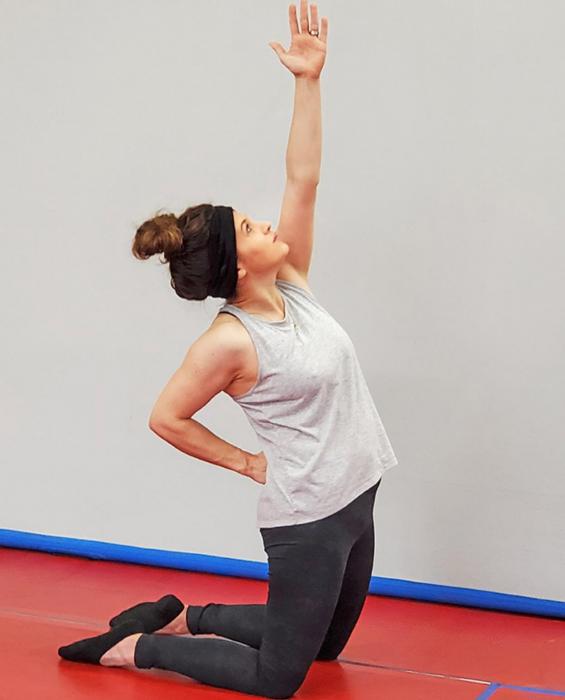 PraiseMoves instructor Rose Wolf goes through the moves with her class, teaching them proper form and reciting the Scripture verses that correspond to each posture.