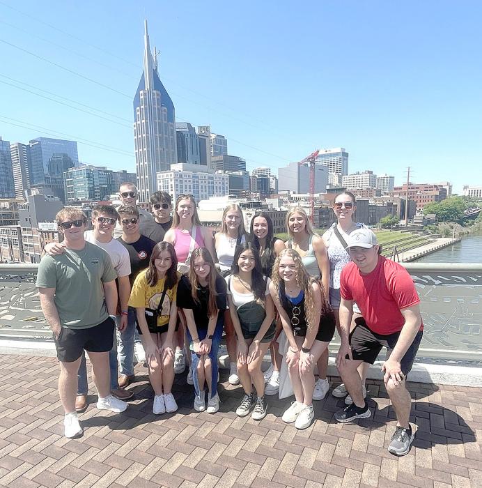The group is shown here posing with the Nashville skyline in the background.
