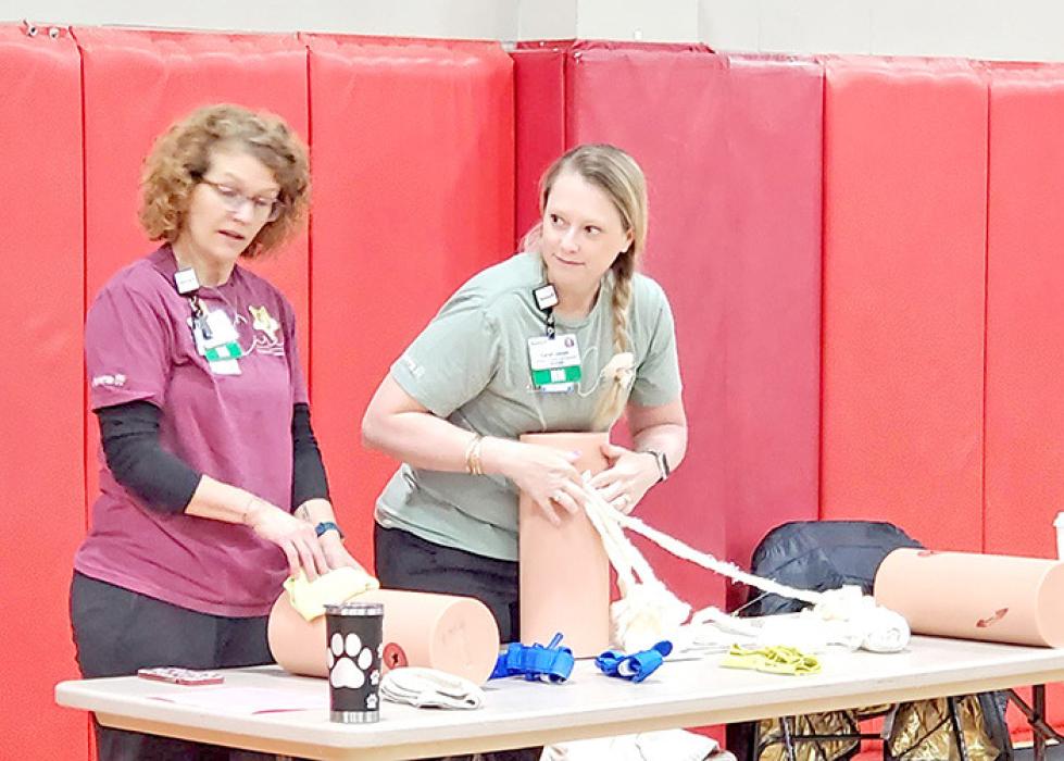 Marija Hay (l) and Sarah Janak (r) of Avera Gregory Hospital taught the students how to stop the bleeding in serious injuries.