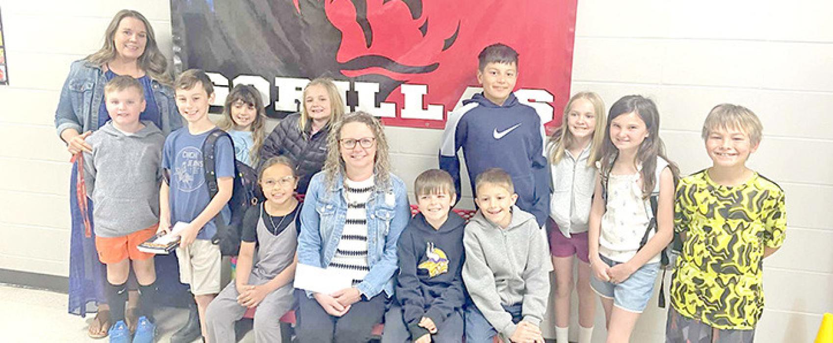 The Help Squad, along with Oaklee’s mother Halee, presented a check to Superintendent Sara Anderson for her mother Sally Miller, who has cancer. (Submitted photo)