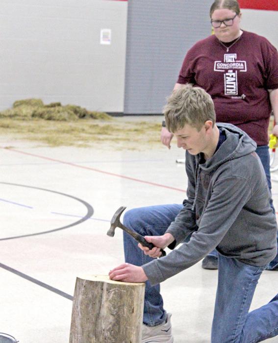 Sophomore Caleb Sinclair at “Nail Driving” station.