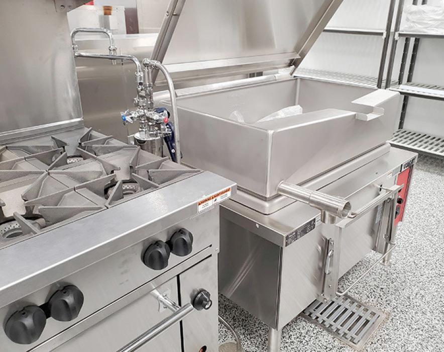 The tilt skillet can cook large amounts of foods. It tilts to drain food or to fill pans for serving.
