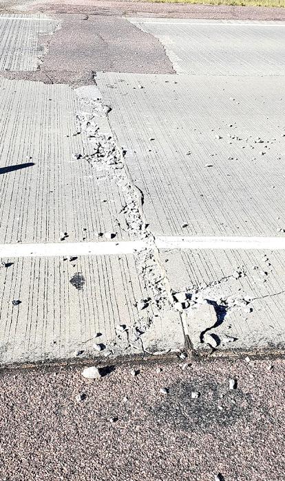 Shown above is one of the two spots on Hwy. 18 where the concrete road heaved up from extreme heat and crumbled, leaving behind rubble and a sizable gap that could create a hazard for drivers.