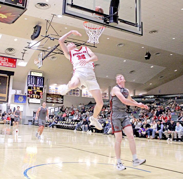 Kolt Keiser shows some moves to get to the basket against a Corsica-Stickney defender in Saturday’s win. (Photo by Sara Anderson)