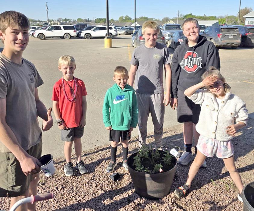 In addition to filling the Main Street planters, the first and seventh graders filled the planters at the school.