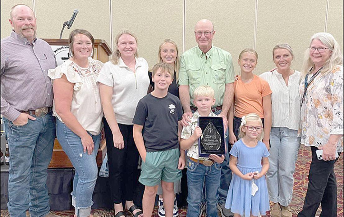 Dr. Gary Straight’s family surprised him as he received the South Dakota Veterinary Medical Association’s Distinguished Service Award at their annual banquet on August 15, 2024. Pictured are back row, l to r: son Jim and his wife Halie, daughter Sarah, granddaughter Gracelyn, Gary, granddaughter Henlee, daughter-in-law Jill, and Marile. Front row, l to r: grandsons Fletcher and Owen, and granddaughter Eliza.