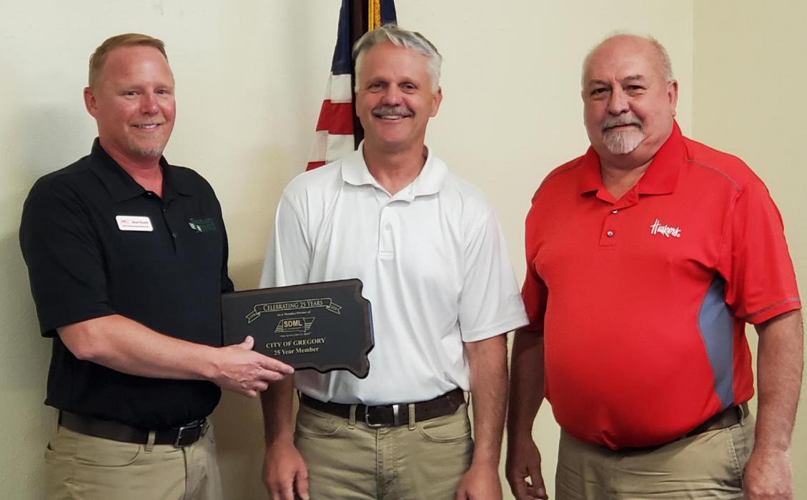 Brad Wilson of the South Dakota Municipal League Workers Compensation Fund presented a 25-year member plaque to the city during the city council meeting Monday evening. Pictured l to r, Brad Wilson, Mayor Scott Anshutz, and City Administrator Al Cerny.