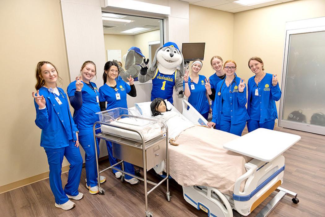 South Dakota State University College of Nursing students pose with Jack the Jackrabbit in a simulation lab at the newly renovated and expanded nursing facility at BHSU-Rapid City.