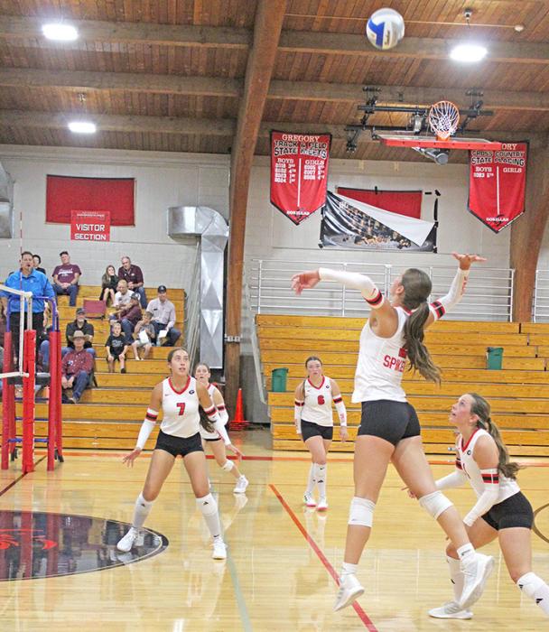 #7 Brynn Bearshield, #8 Bayley O’Bryan, and Abby Holmes watch as #2 Dani VanDerWerff jumps high to send the ball over the net. (Photo by Maya Hull)