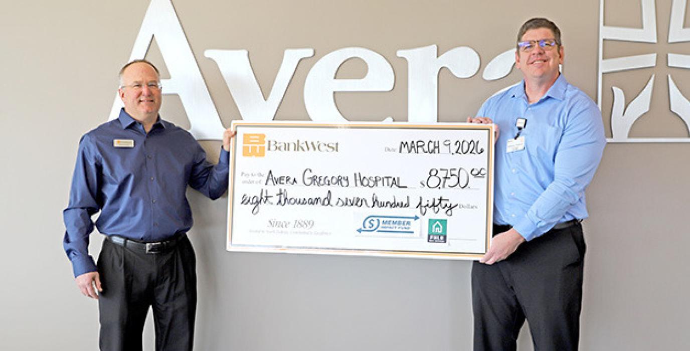 BankWest’s Branch Manager David Kotrba presents a check to Avera Gregory’s CEO Anthony Timanus.
