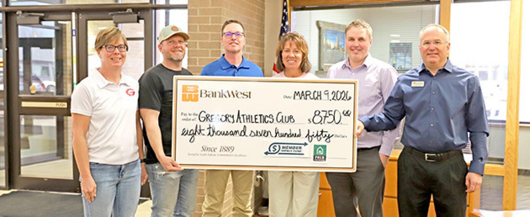 BankWest’s Branch Manager David Kotrba and Business Development Officer Jason Grim present a check to Gregory Athletic Club board members Kellie Stukel, Patrick Shaffer, Beth Leber and Hank Wonnenberg.
