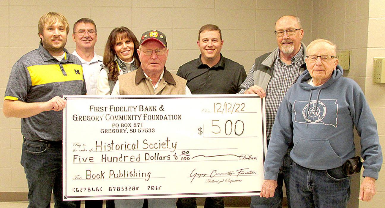 Members of the First Fidelity Bank and the Gregory Community Foundation, presented a check in the amount of $500.00 to Richard Rubel, center, a member of the Gregory County Historical Society, to help with the cost of publishing the Gregory County School books. Members present included, l to r: Kevin Myrmoe, Sam Flakus, Rhonda Waterbury, Mark Braun, Gregg Drees, and Emmett Kotrba.