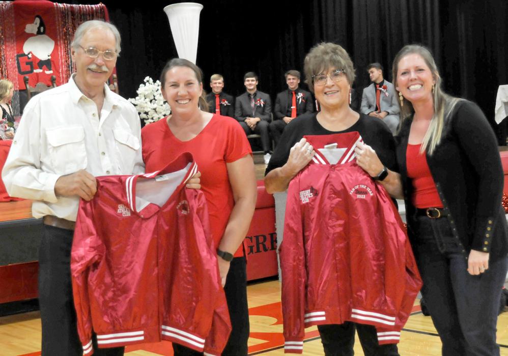 Dr. John Malm and Donna Schmitz were named Gregory Gorilla fans of the year by the Gregory Athletics Club. Presenting them with jackets were Karen Timanus, l, and Lacey Collins, r.