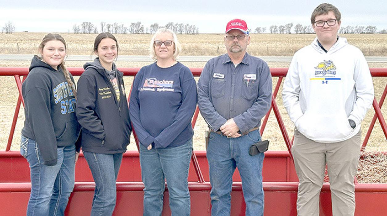 Standing in front of a double bale feeder, were l to r: Ava Kerner, officer, Avery Zeisler, officer, Laura and Roger Petersen, owners of Ranchers Livestock Equipment, and Leo Mosterd, officer from Burke.
