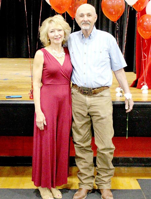 John Hansen is joined by his wife Cheri at the Gregory High School graduation, where he was honored for his 50 years with the school.