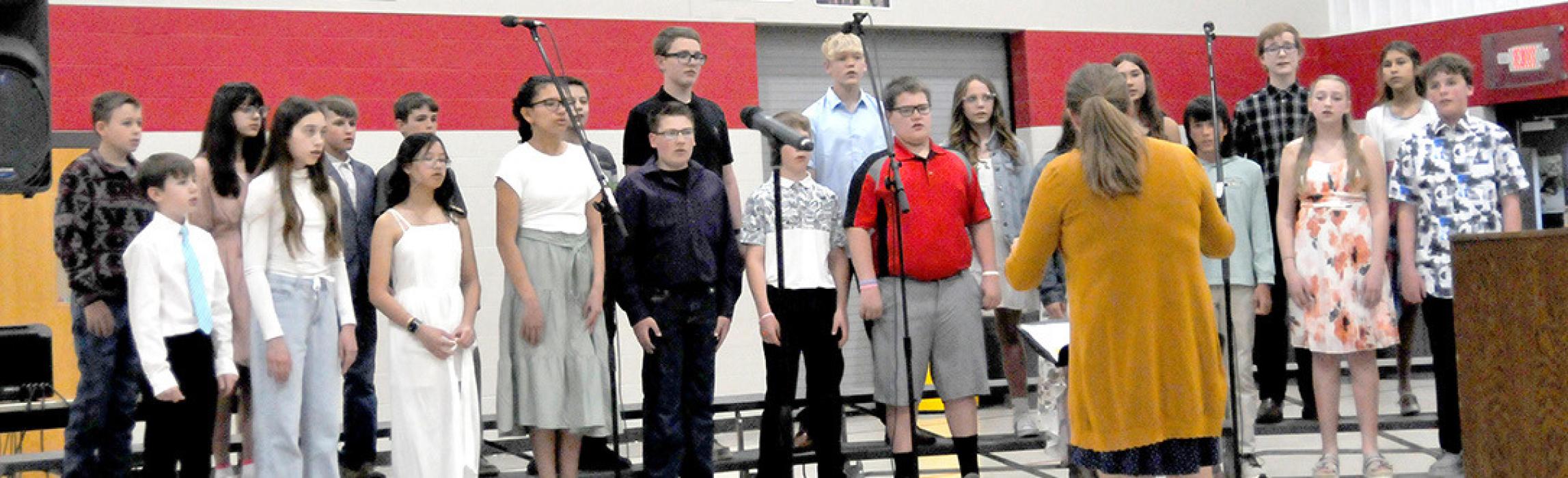 Director Katie Opp led the 6th grade choir to kick off the program.