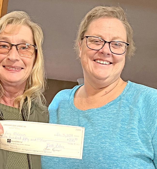 IOOF’s Lisa Kerner presentes a check to Amy Meinen to provide some financial relief as she battles cancer.