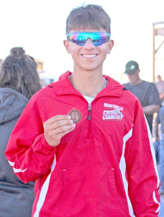 Junior Luke Barreto brought home a medal for his 25th place finish at the state cross country meet. (Photo by Jeff Determan)