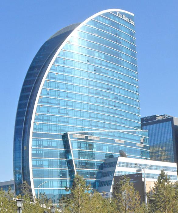 The Blue Sky Tower is an ultra-modern 25 story, 105 meters (344 ft) tall steel and glass skyscraper in Ulaanbaatar that houses a 200-room hotel, luxury apartments, restaurants, as well as office and conference spaces. Mongolians often refer to it derisively as “the meat cleaver” or “the sail boat.”