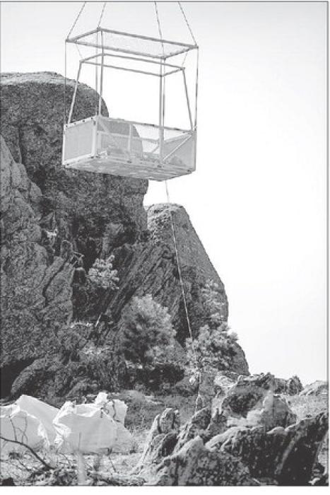 Chief Warrant Officer 3 Anton Oerlline guides a heli-basket to be loaded with fallen trees and debris from around the Mount Rushmore National Memorial on April 11, 2024. The steep and rocky terrain would otherwise be dangerous for the National Park Service personnel and thanks to the SDNG’s training, equipment and capabilities they were able to safely haul away 3 loads during the mission. (U.S. Army National Guard photo by Staff Sgt. Breanne Donnell)