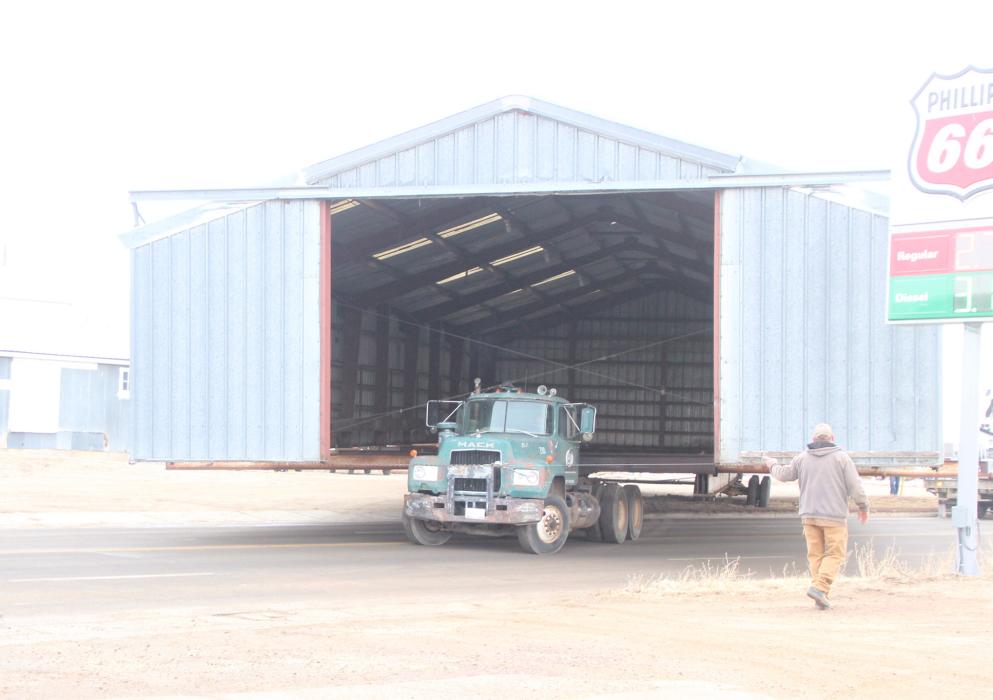 Moving a building is big news. On Monday morning, Klein’s House Moving crew moved a large metal building from the far east side of Cenex’s property to behind the fuel station. This move had been planned for some time as part of the elevator closing. The building will be used for storage in its new location. (Photo by Shelby Jones)