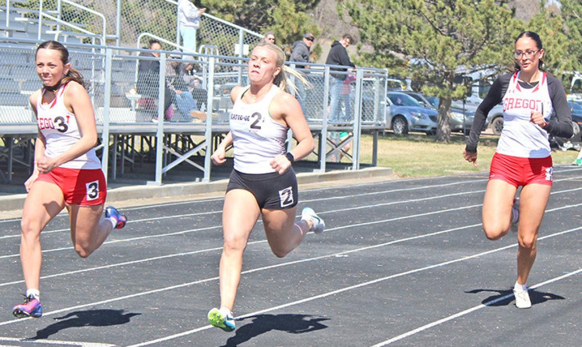 Abby Holmes and Aubree Miller run hard in the 100m sprint. (Photos by Madi Graber, Ella Sperl, and Maya Hull)